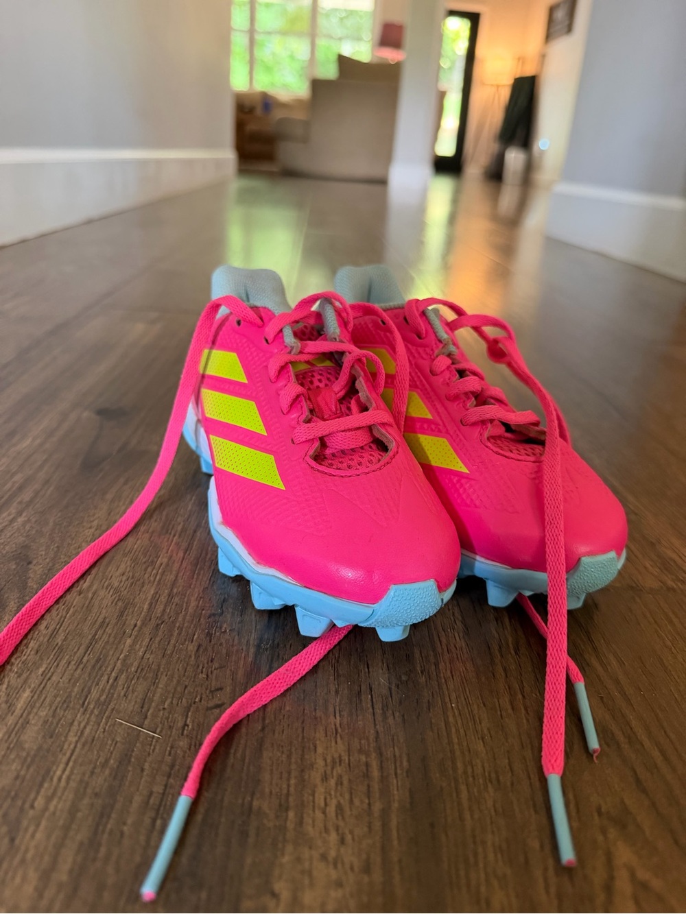 adidas Kids Bright Pink Soccer Cleats with Yellow Stripes and Light Blue Soles